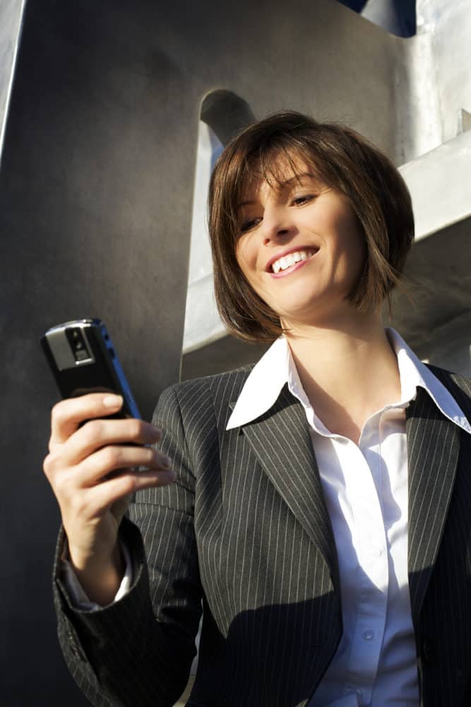 Businesswoman receiving text message