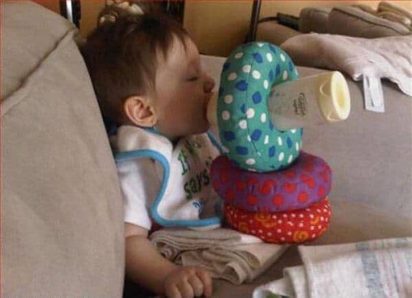 baby bottle propped up on pillows
