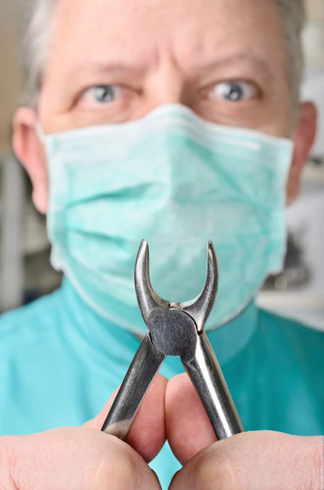 Angry dentist with pliers